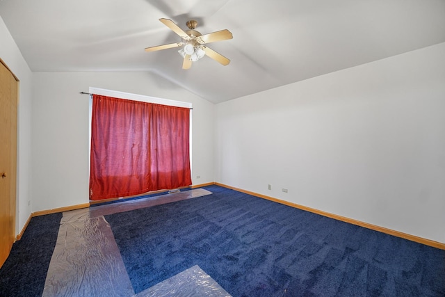 carpeted spare room featuring ceiling fan and lofted ceiling