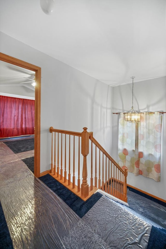 hall with an inviting chandelier