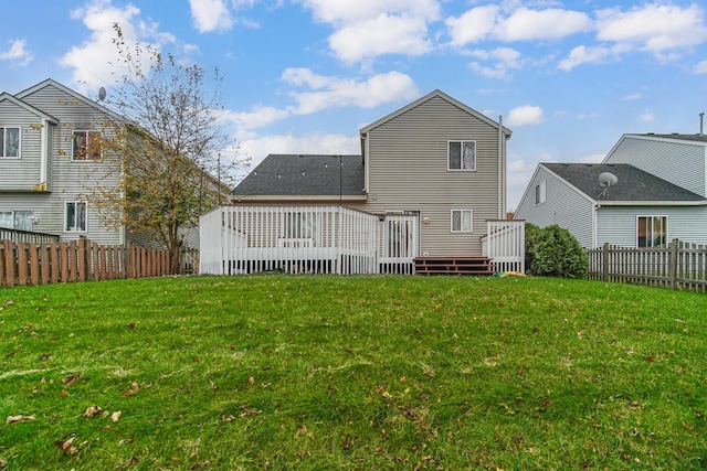 back of property featuring a yard and a deck