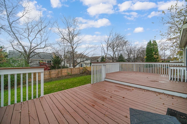 wooden terrace featuring a lawn