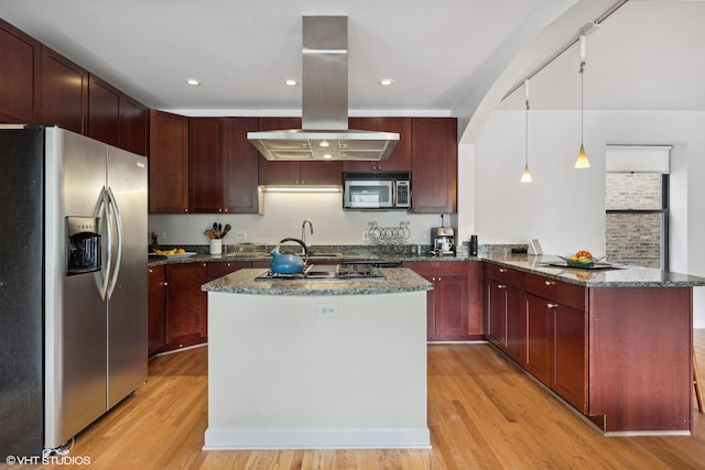 kitchen featuring kitchen peninsula, island exhaust hood, decorative light fixtures, a kitchen island, and appliances with stainless steel finishes