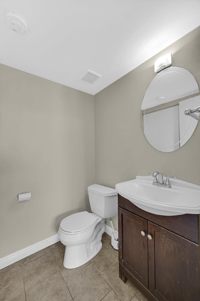 bathroom featuring tile patterned floors, vanity, and toilet