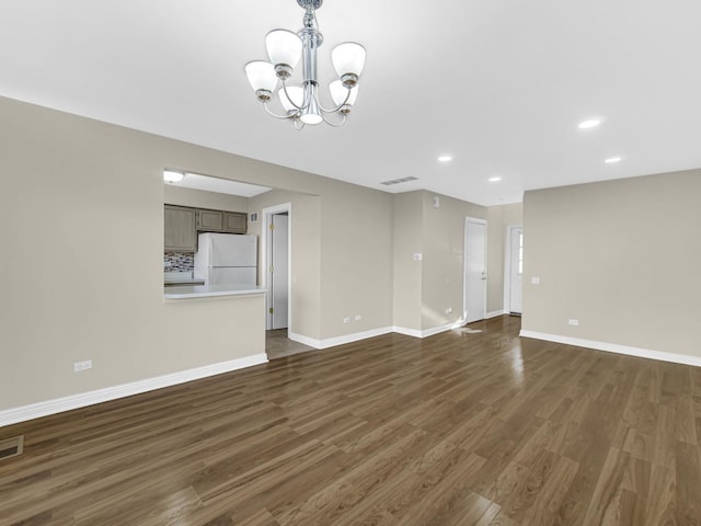 interior space with dark hardwood / wood-style flooring and a notable chandelier