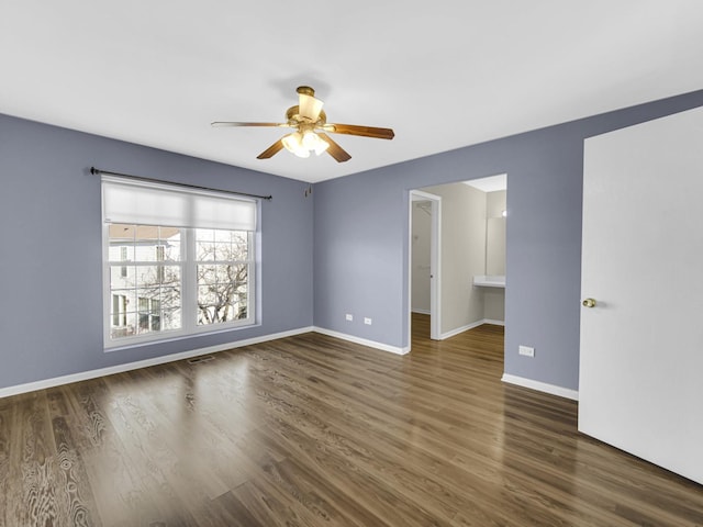 spare room featuring dark hardwood / wood-style flooring and ceiling fan