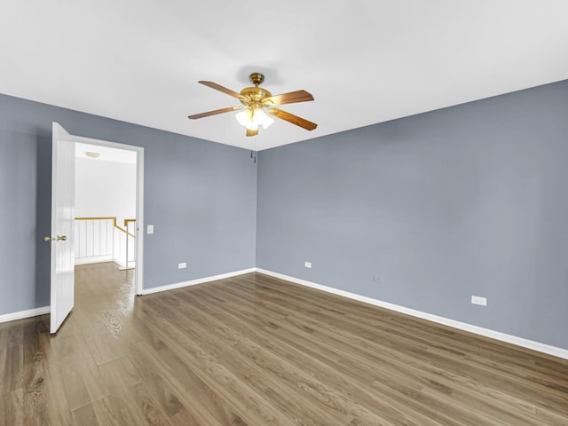 empty room with hardwood / wood-style flooring and ceiling fan