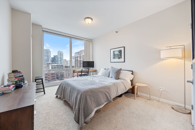 bedroom featuring expansive windows and light colored carpet