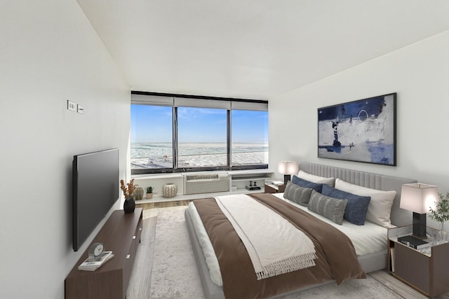 bedroom featuring cooling unit and light wood-type flooring