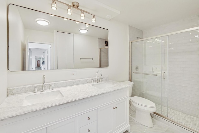 bathroom featuring an enclosed shower, vanity, and toilet