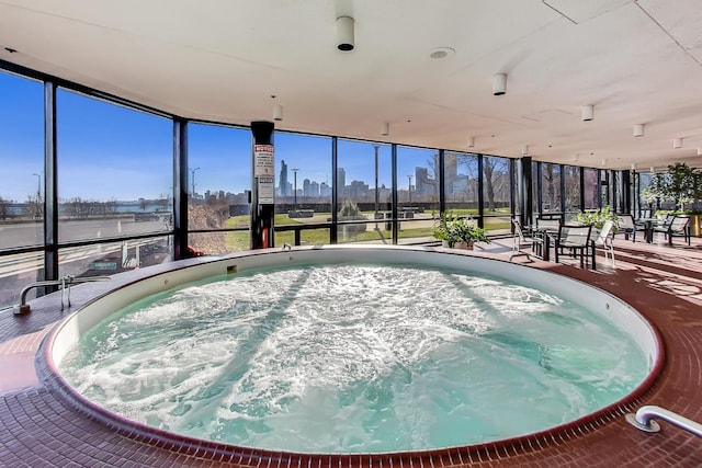 view of swimming pool with an indoor hot tub