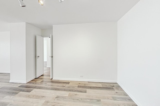 empty room with light hardwood / wood-style flooring