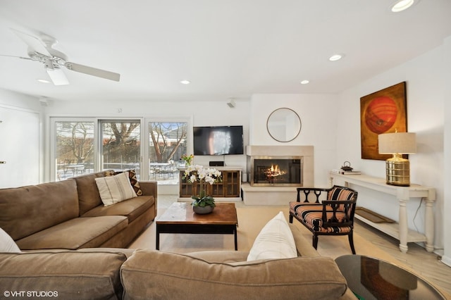 living room with ceiling fan and light hardwood / wood-style floors