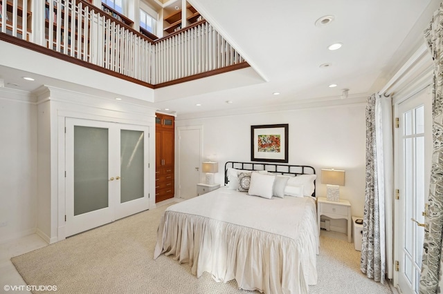 carpeted bedroom featuring a high ceiling and multiple windows