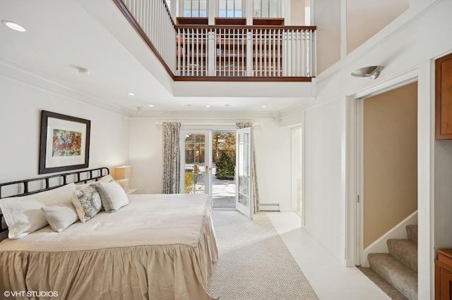 bedroom featuring access to outside, a towering ceiling, a baseboard radiator, and crown molding