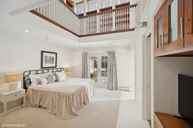 bedroom with a baseboard radiator, light colored carpet, ornamental molding, and a towering ceiling