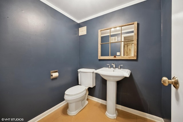 bathroom with toilet and ornamental molding