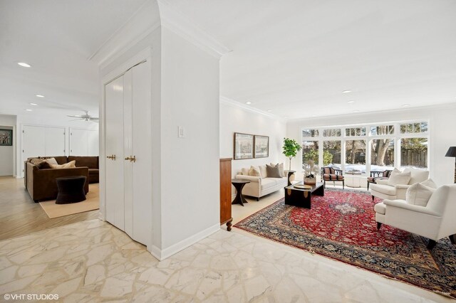 living room featuring ceiling fan and crown molding