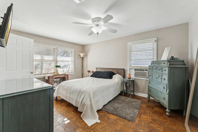 bedroom featuring dark parquet flooring, cooling unit, and ceiling fan