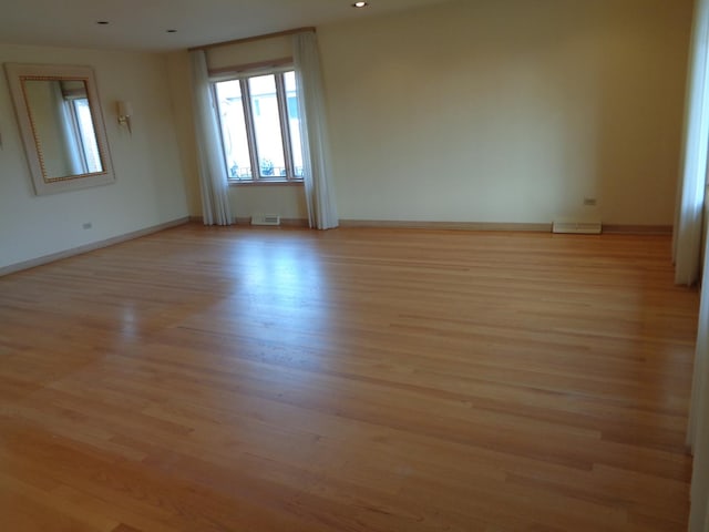 unfurnished room with light hardwood / wood-style flooring