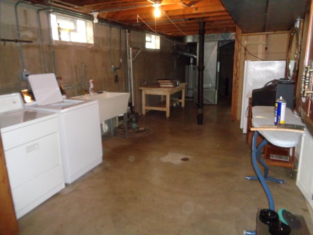 basement featuring washer and clothes dryer and sink