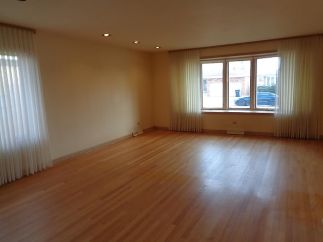 empty room with light hardwood / wood-style floors