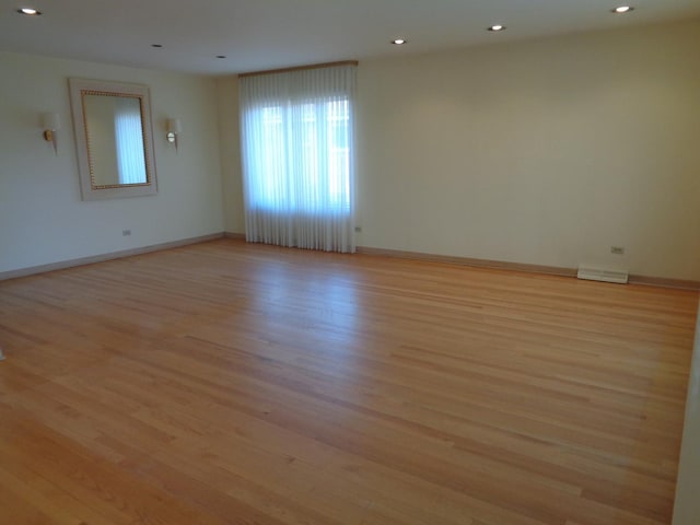 empty room with light hardwood / wood-style floors