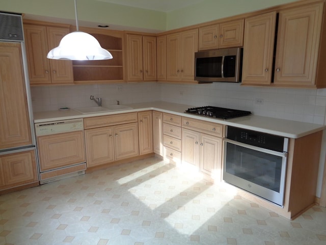 kitchen featuring decorative light fixtures, sink, appliances with stainless steel finishes, and tasteful backsplash