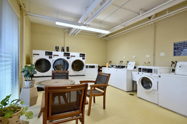 clothes washing area with independent washer and dryer