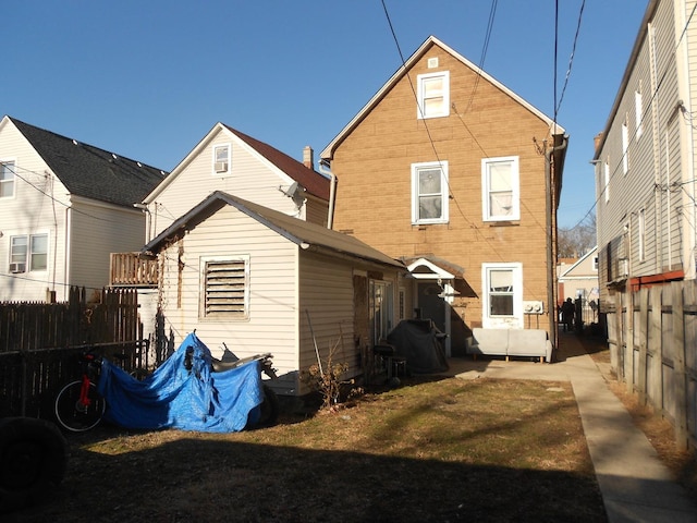 rear view of house with a yard