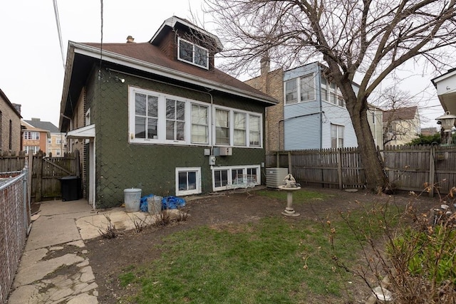 rear view of property featuring central AC unit