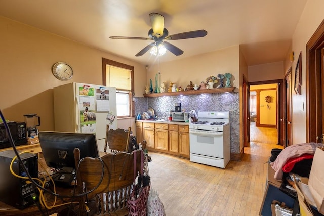 kitchen with decorative backsplash, white appliances, light hardwood / wood-style floors, and ceiling fan