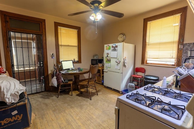 kitchen featuring ceiling fan, light wood-type flooring, and white appliances