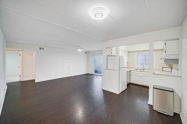 kitchen featuring dark hardwood / wood-style floors, white cabinetry, a healthy amount of sunlight, and sink