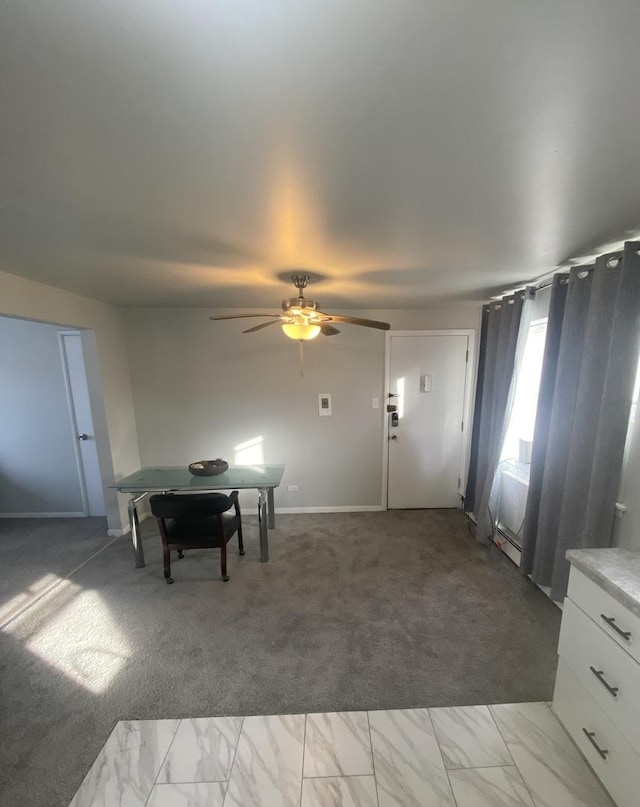 interior space featuring carpet flooring and ceiling fan