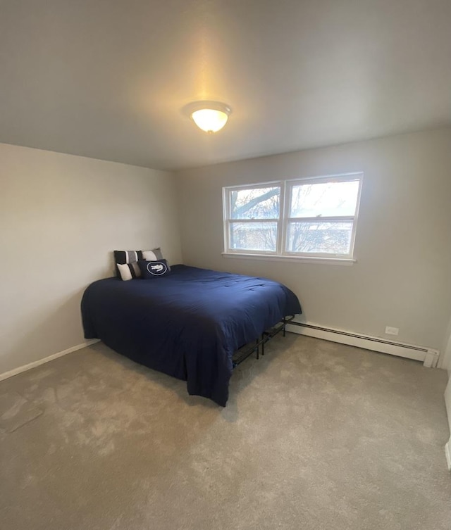 carpeted bedroom with a baseboard radiator