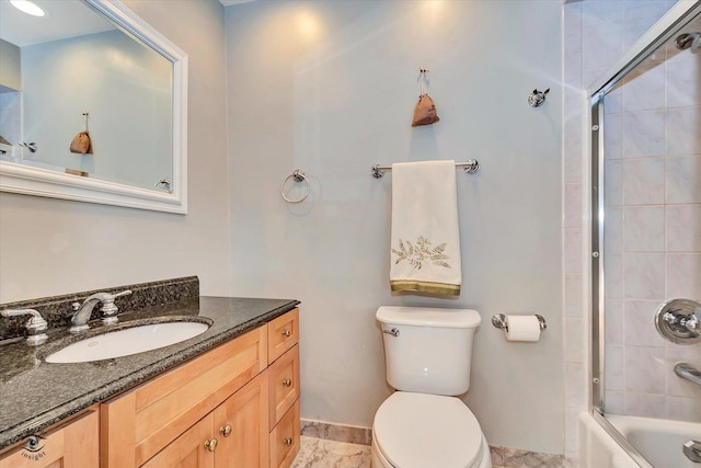 full bathroom featuring shower / bath combination with glass door, vanity, and toilet