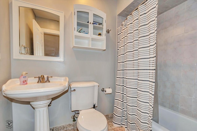 full bathroom featuring sink, toilet, and shower / bath combination with curtain