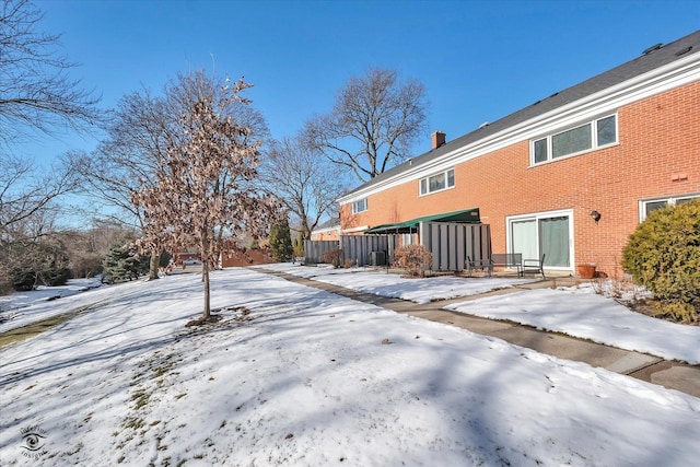 view of snow covered rear of property