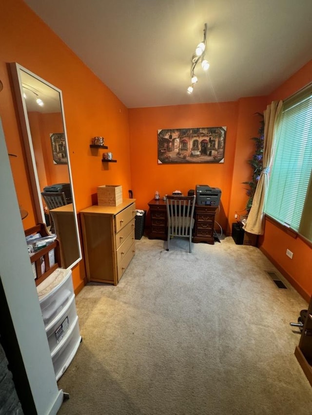 carpeted home office featuring rail lighting