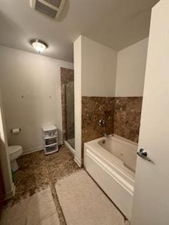 bathroom featuring shower with separate bathtub and toilet