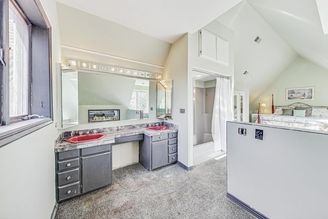 bathroom with a shower with curtain, vanity, and vaulted ceiling