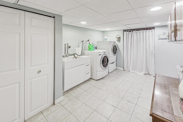 clothes washing area featuring washing machine and dryer and sink