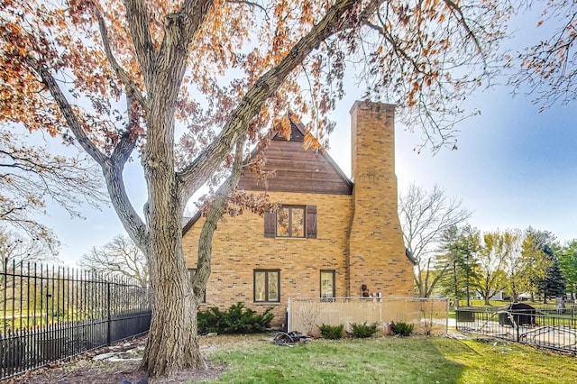 back of house with a lawn