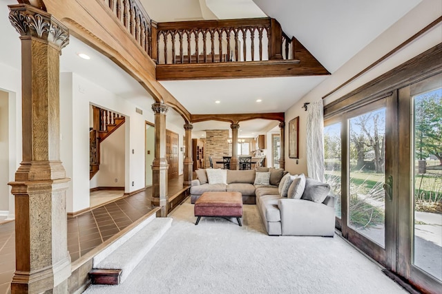 carpeted living room with decorative columns