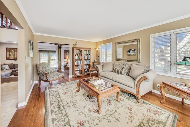 living room with light hardwood / wood-style flooring and ornamental molding