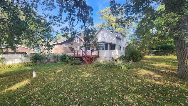 exterior space featuring a lawn and a deck