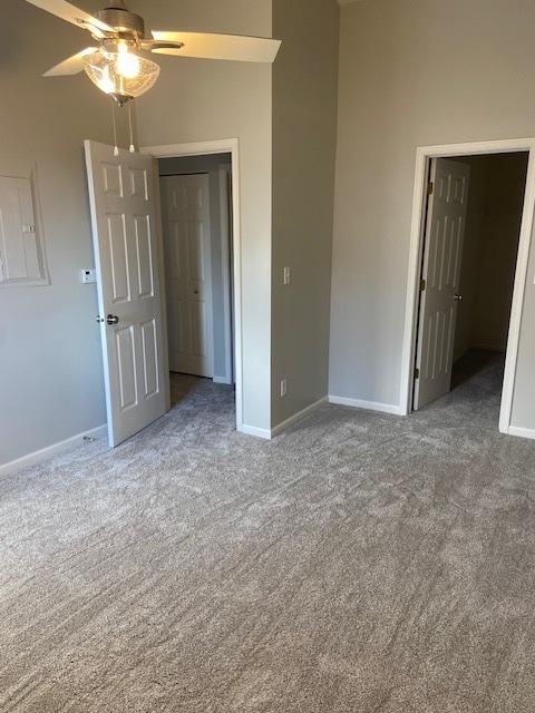 interior space with carpet and ceiling fan