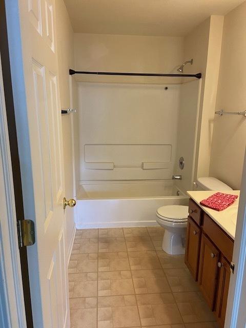 full bathroom featuring shower / bathing tub combination, vanity, and toilet