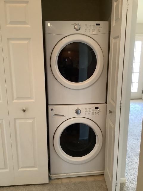 laundry room featuring stacked washing maching and dryer