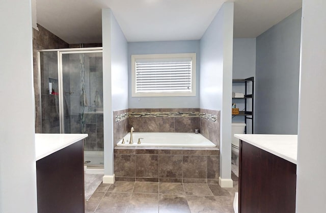 full bathroom featuring tile patterned floors, vanity, separate shower and tub, and toilet