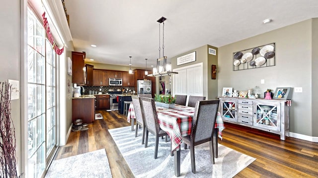 dining room with sink and dark hardwood / wood-style floors